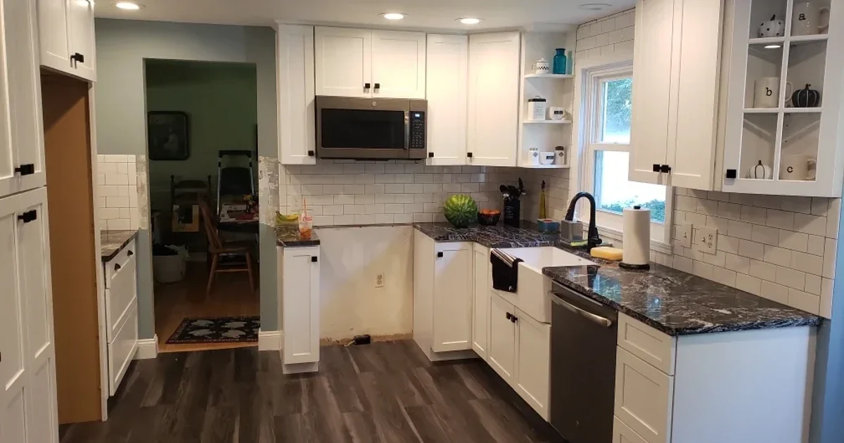 Completed Rochester-area kitchen remodel with white cabinets and stone countertops