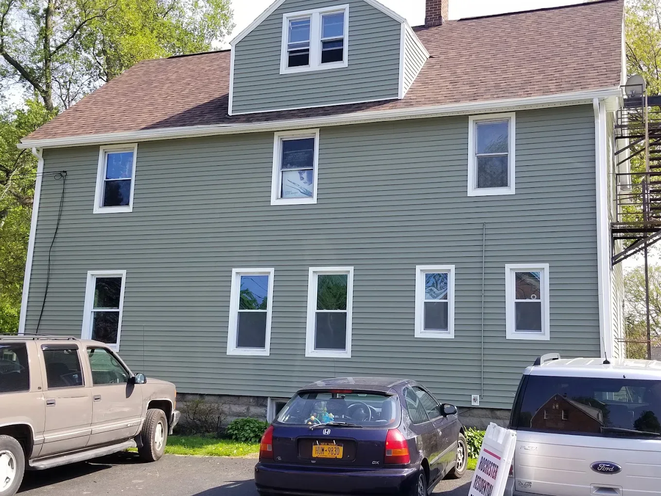 Two-story house with new blue-gray siding