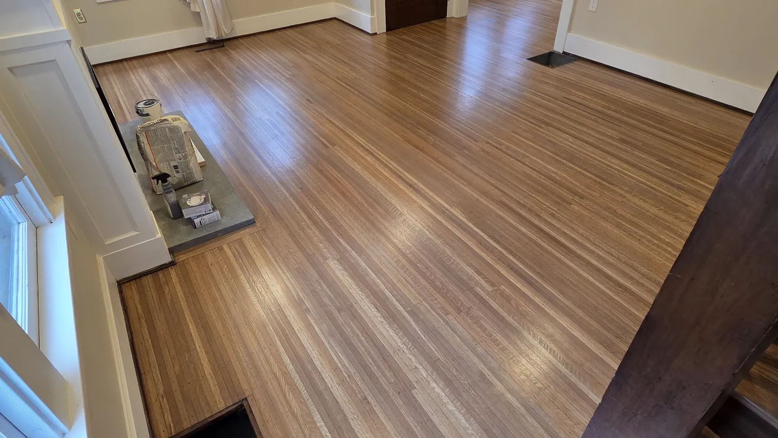 Refinished hardwood floor in a bright living room