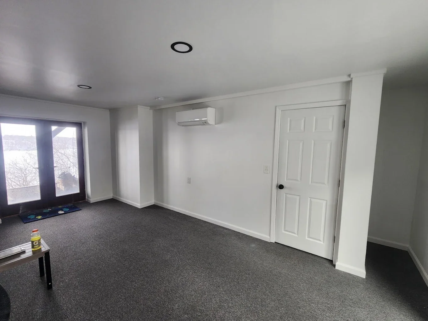 Remodeled interior room with gray flooring