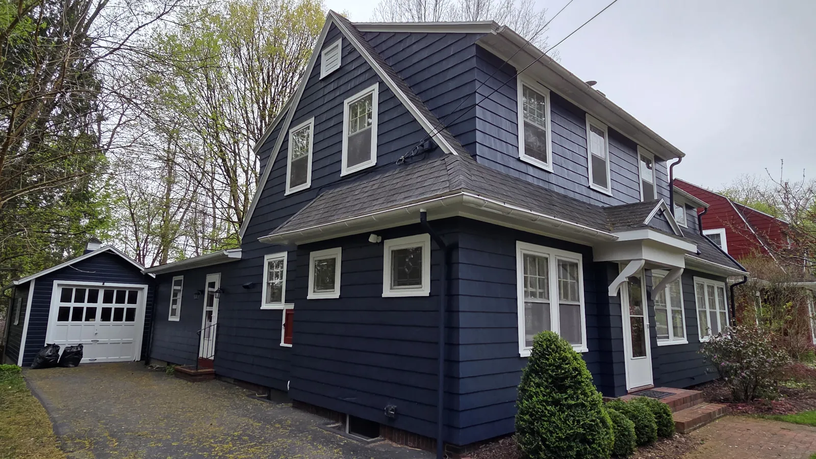 Two-story home with navy siding and white window trim