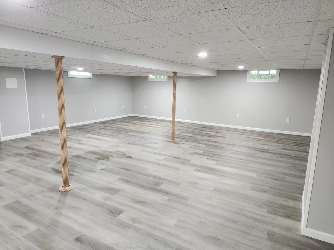 Finished basement with gray plank flooring