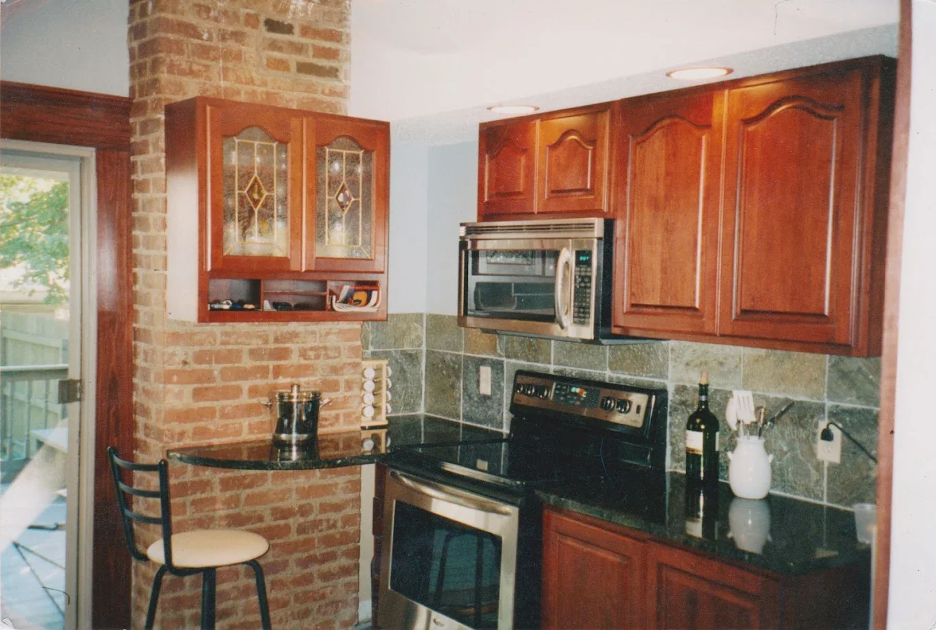 Kitchen with wood cabinets and tiled backsplash