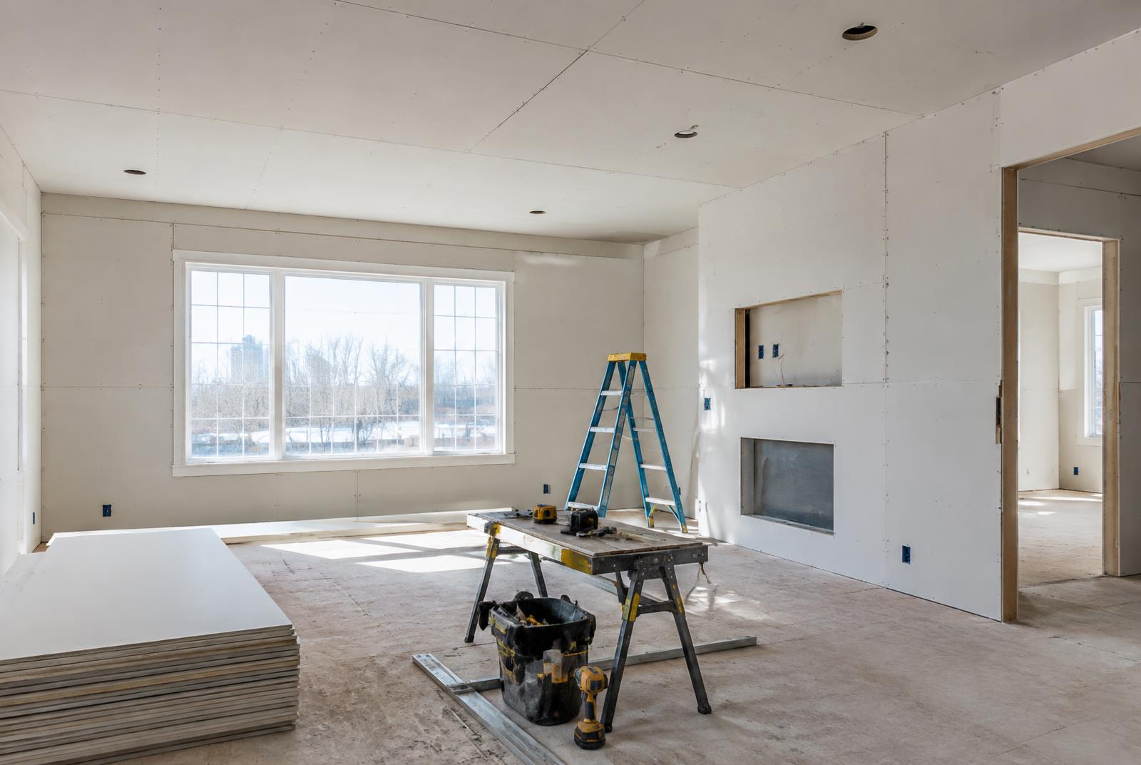 New drywall installed in a bright Rochester living room remodel